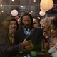 Keanu Reeves as Thomas Anderson holds a Game Award, looking somewhat lost in life, while people around him appear celebratory.
